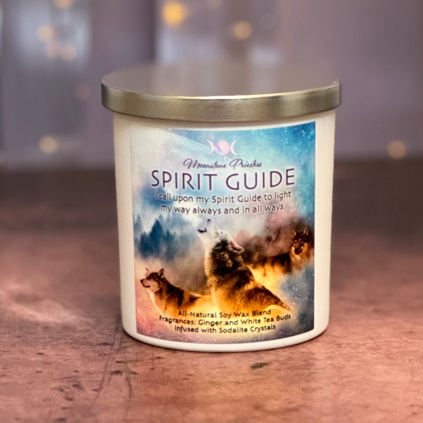 Candle with 'Spirit Guide' label featuring nature-themed design on a wooden surface.