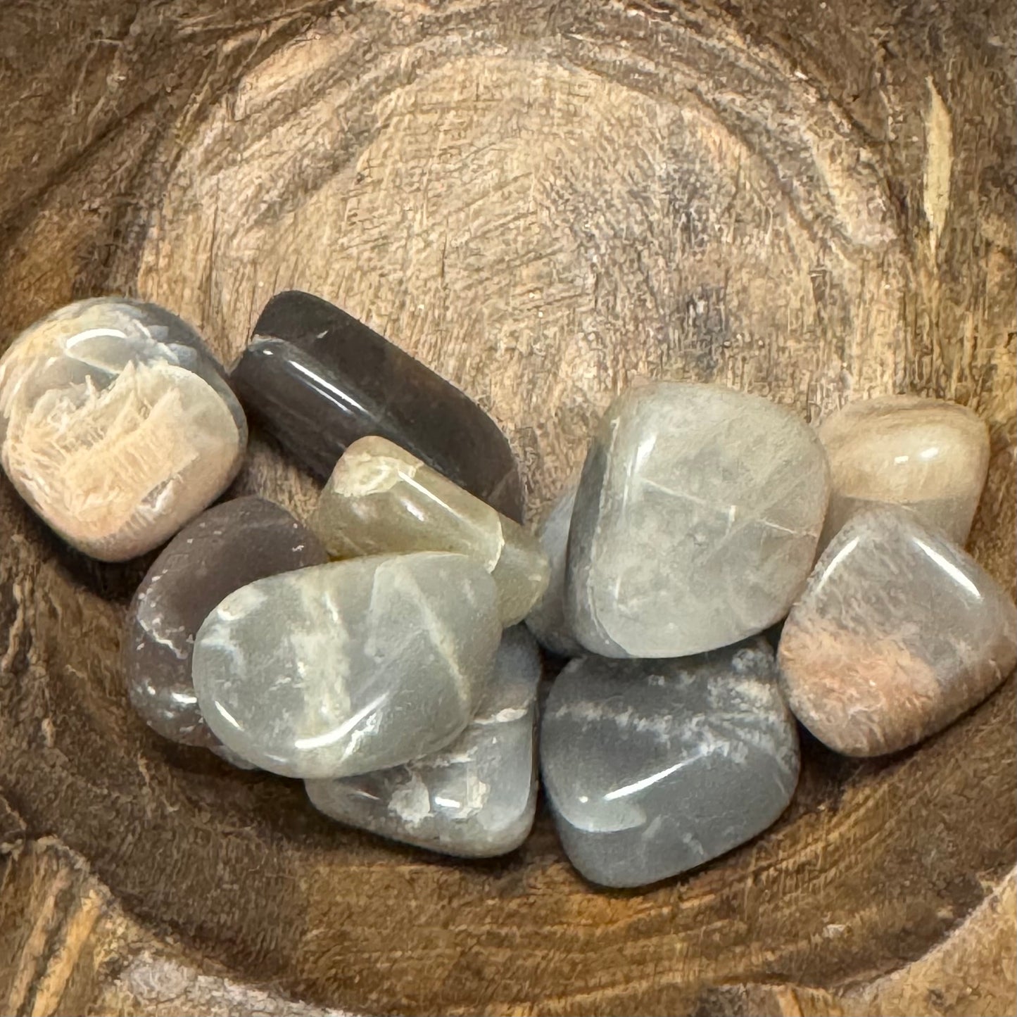 Collection of polished stones on a wooden surface