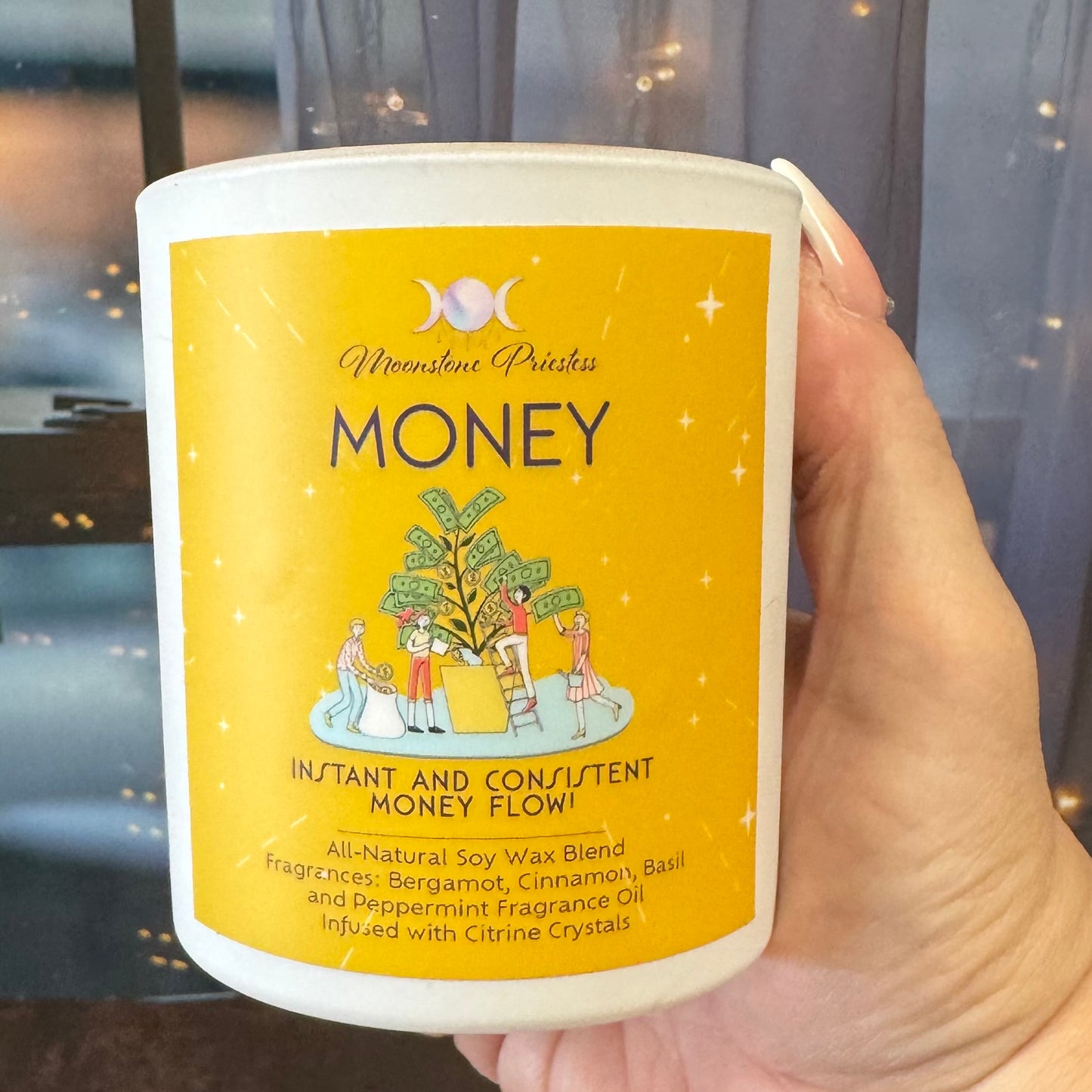 Candle labeled 'Money' held by a hand with a blurred background