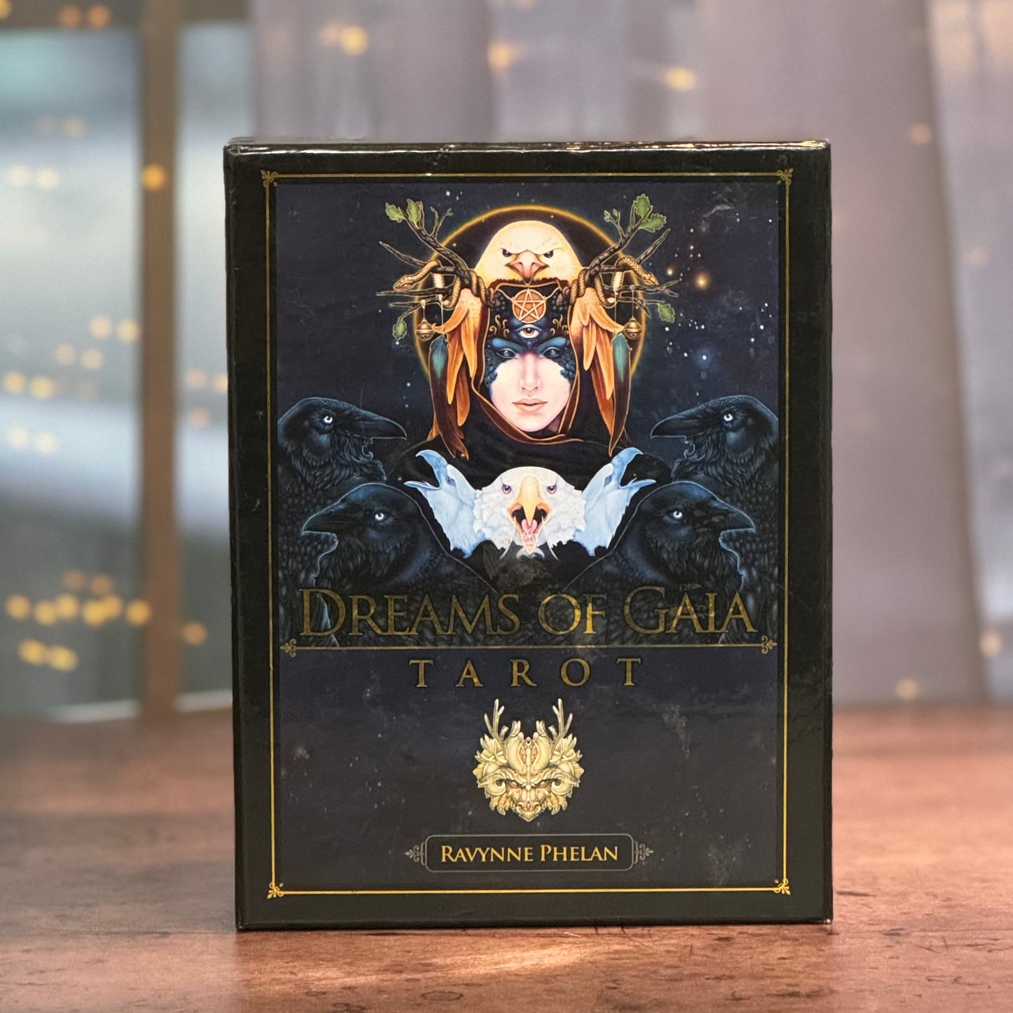 Tarot card deck titled 'Dreams of Gaia' with artistic cover on a wooden surface.