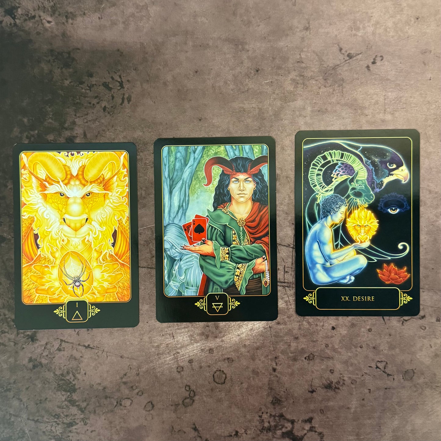 Three tarot cards displayed on a textured surface