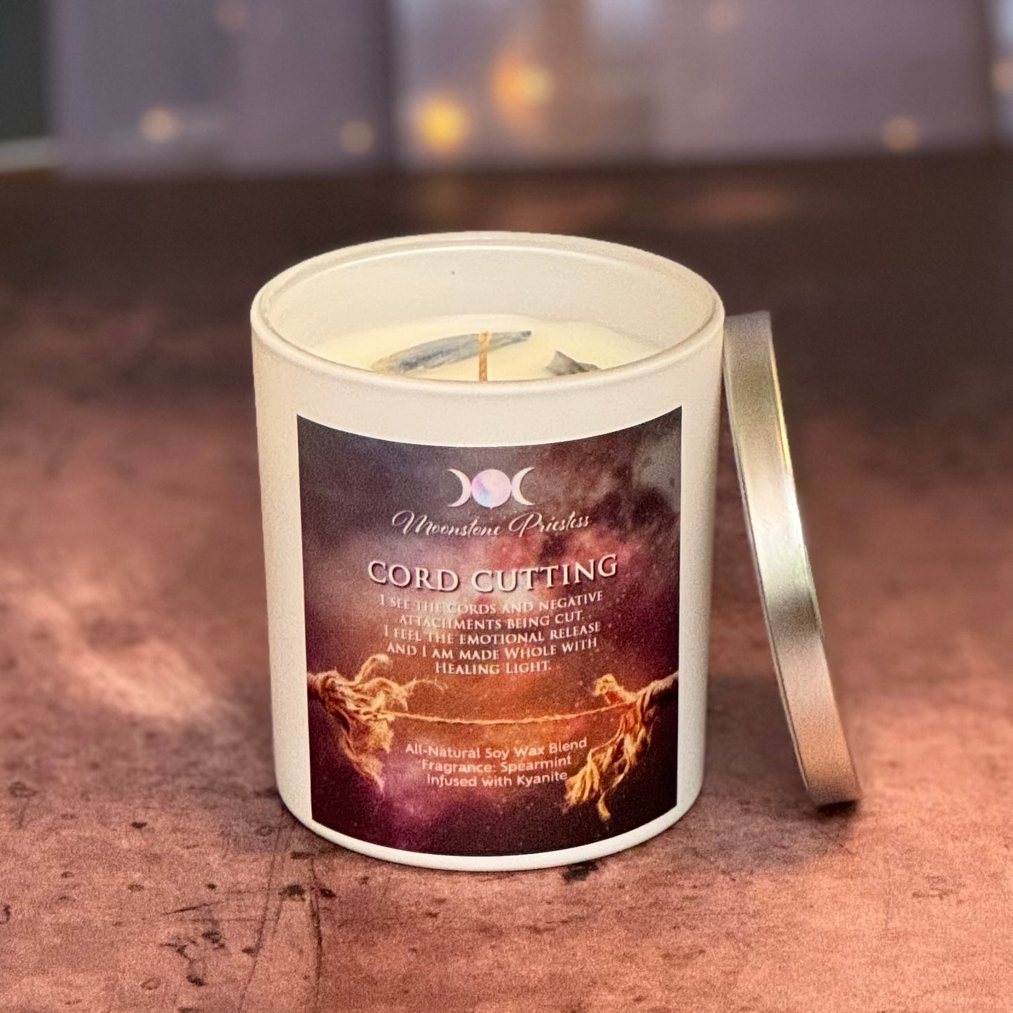 Candle with a label on a wooden surface
