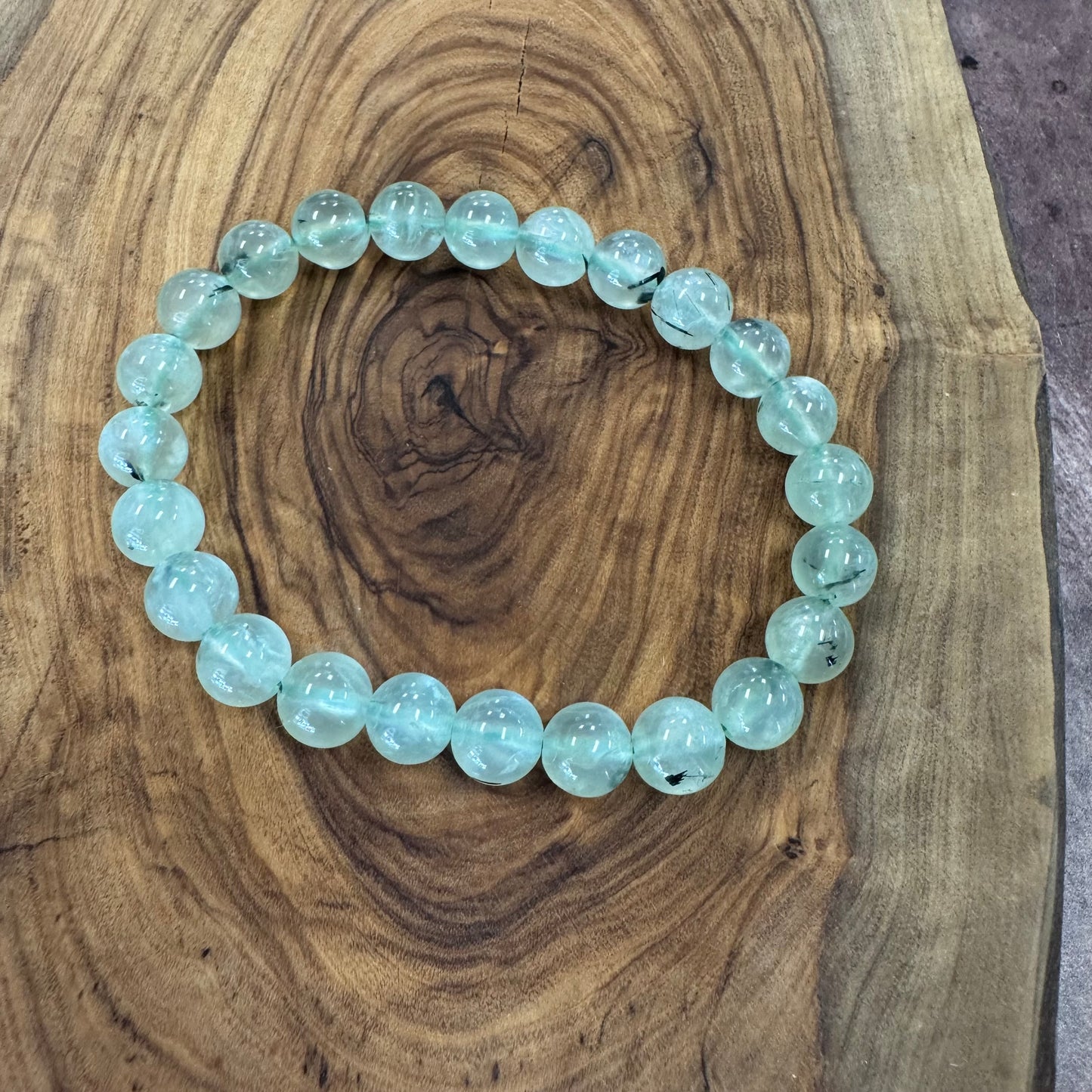 Light blue beaded bracelet on a wooden surface