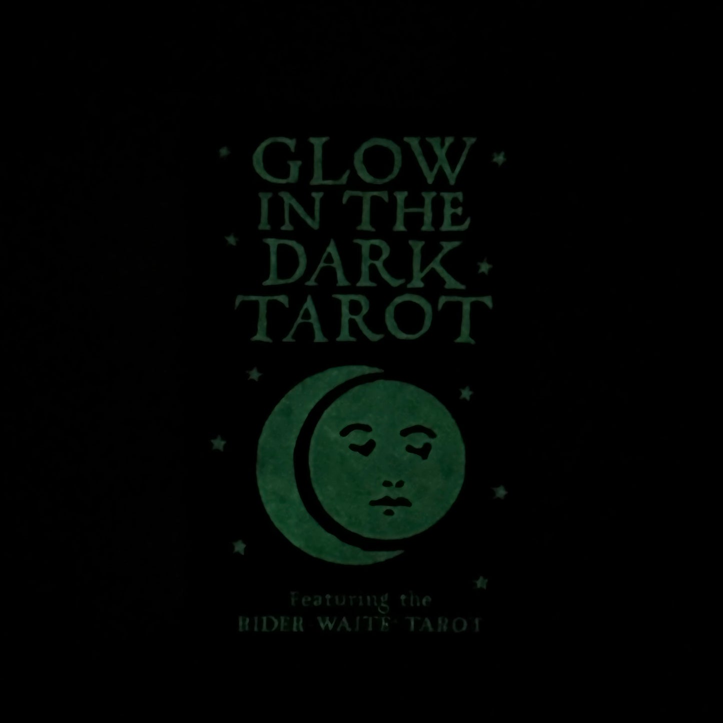 Glow in the Dark Tarot book cover with moon and face design on black background