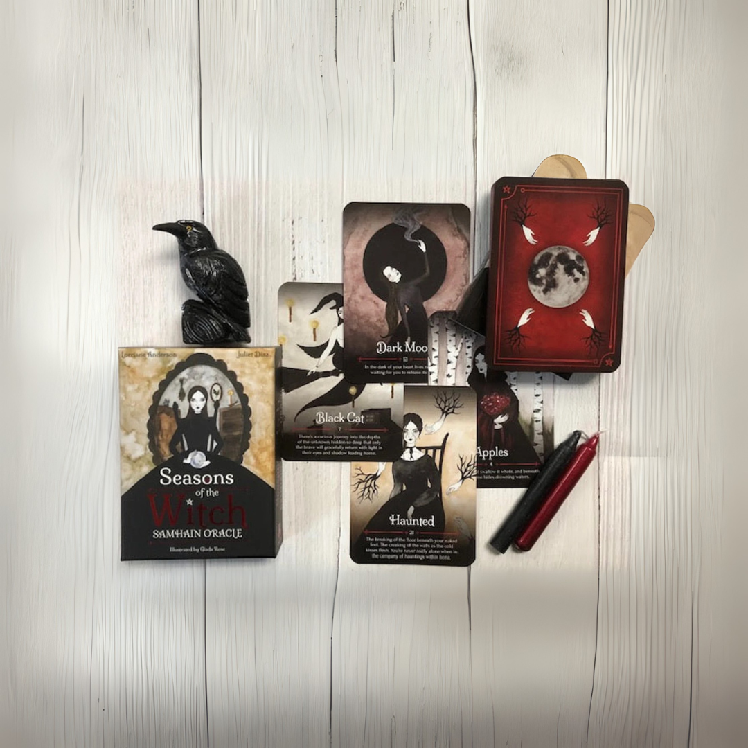 Collection of tarot cards and a book on a wooden surface
