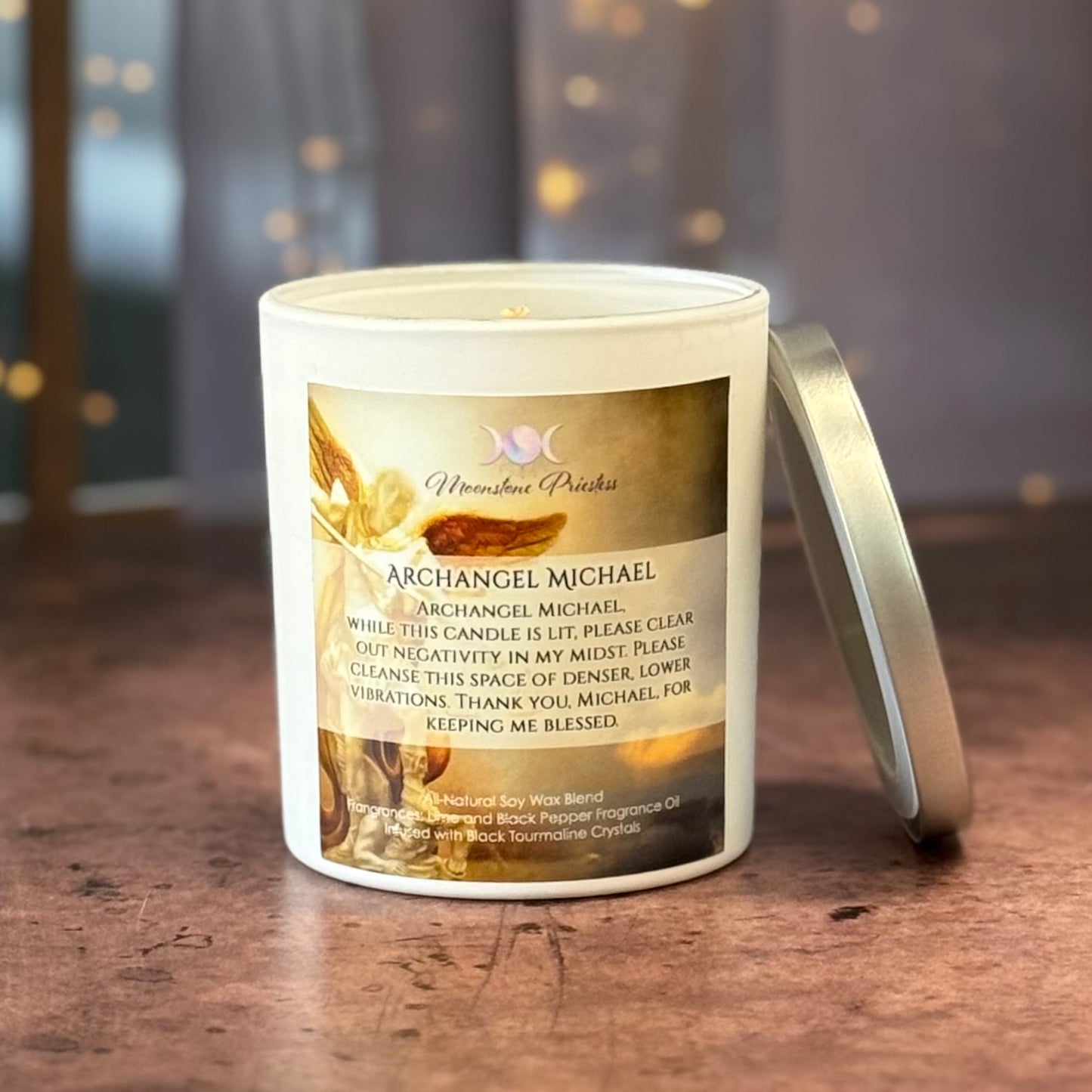 Candle with a label featuring text and imagery on a wooden surface