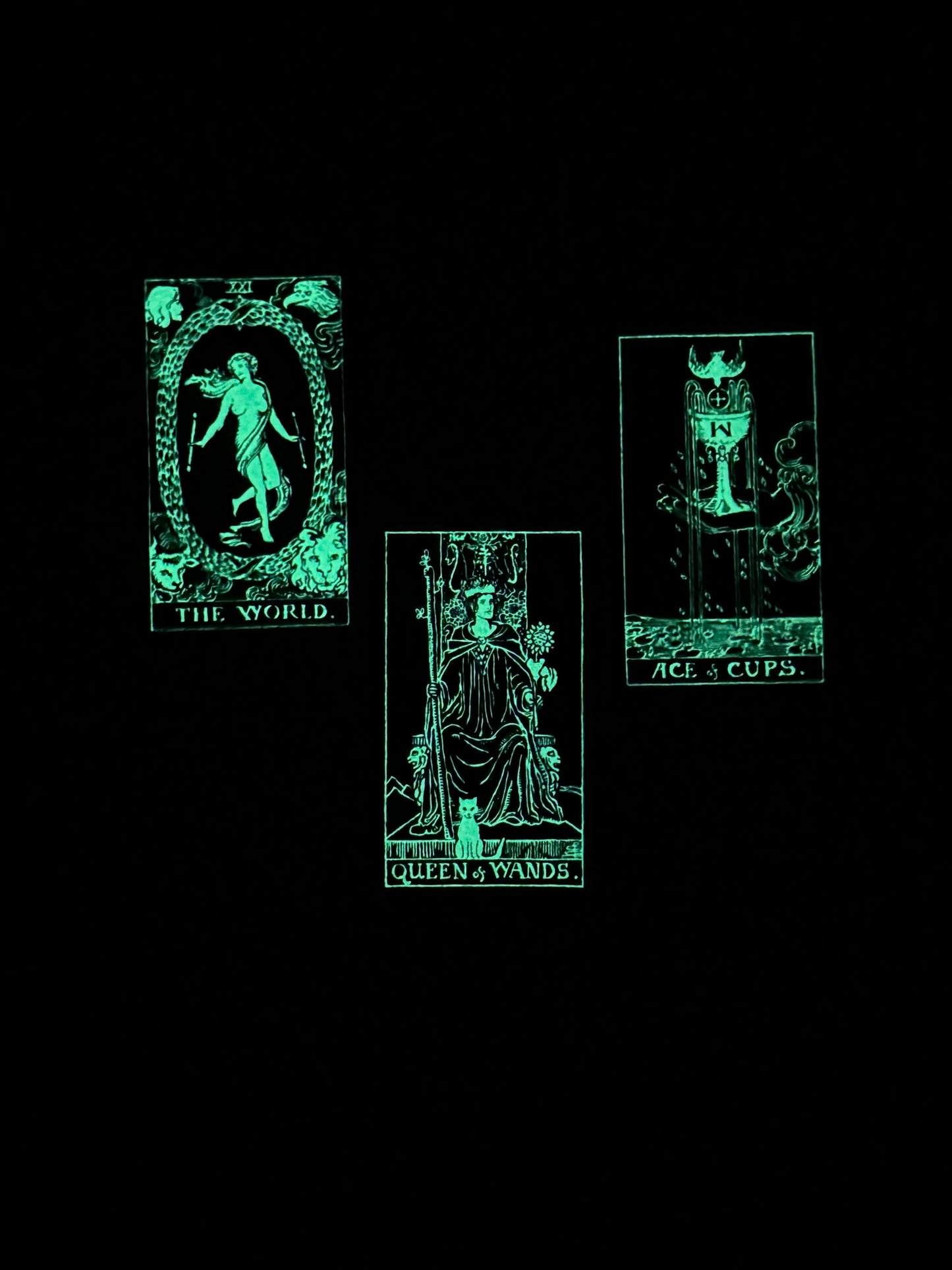 Glowing green tarot cards on a black background