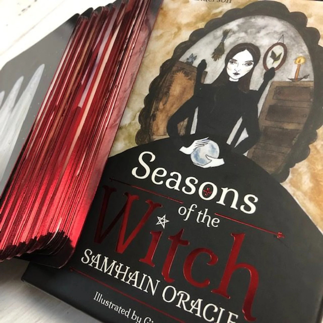 Book titled 'Seasons of the Witch Samhain Oracle' with a witch illustration on the cover.