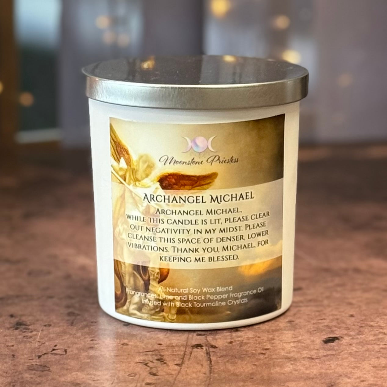 Candle with a label featuring 'Archangel Michael' on a wooden surface.