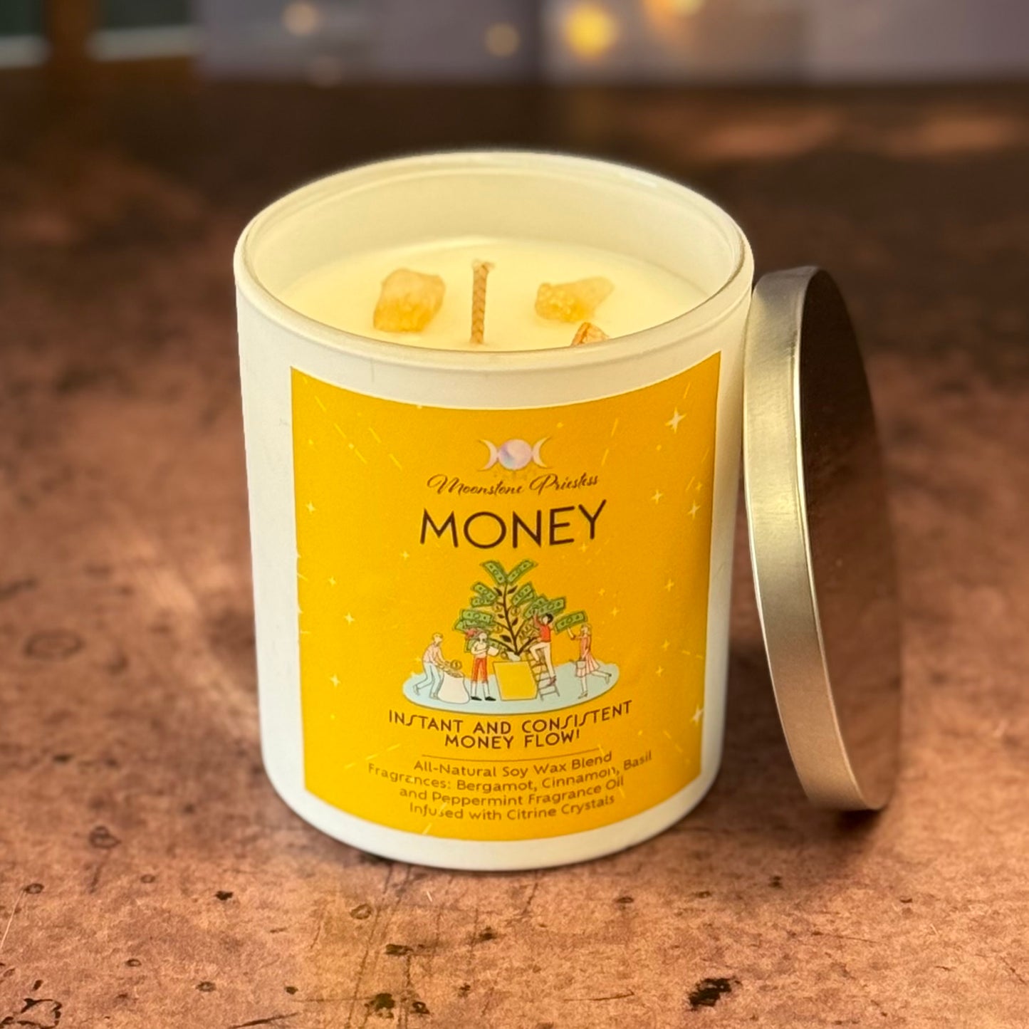 Candle labeled 'Money' with a yellow label on a wooden surface