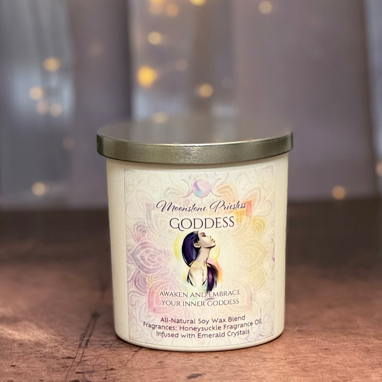 Candle labeled 'Goddess' with a decorative design on a wooden surface.