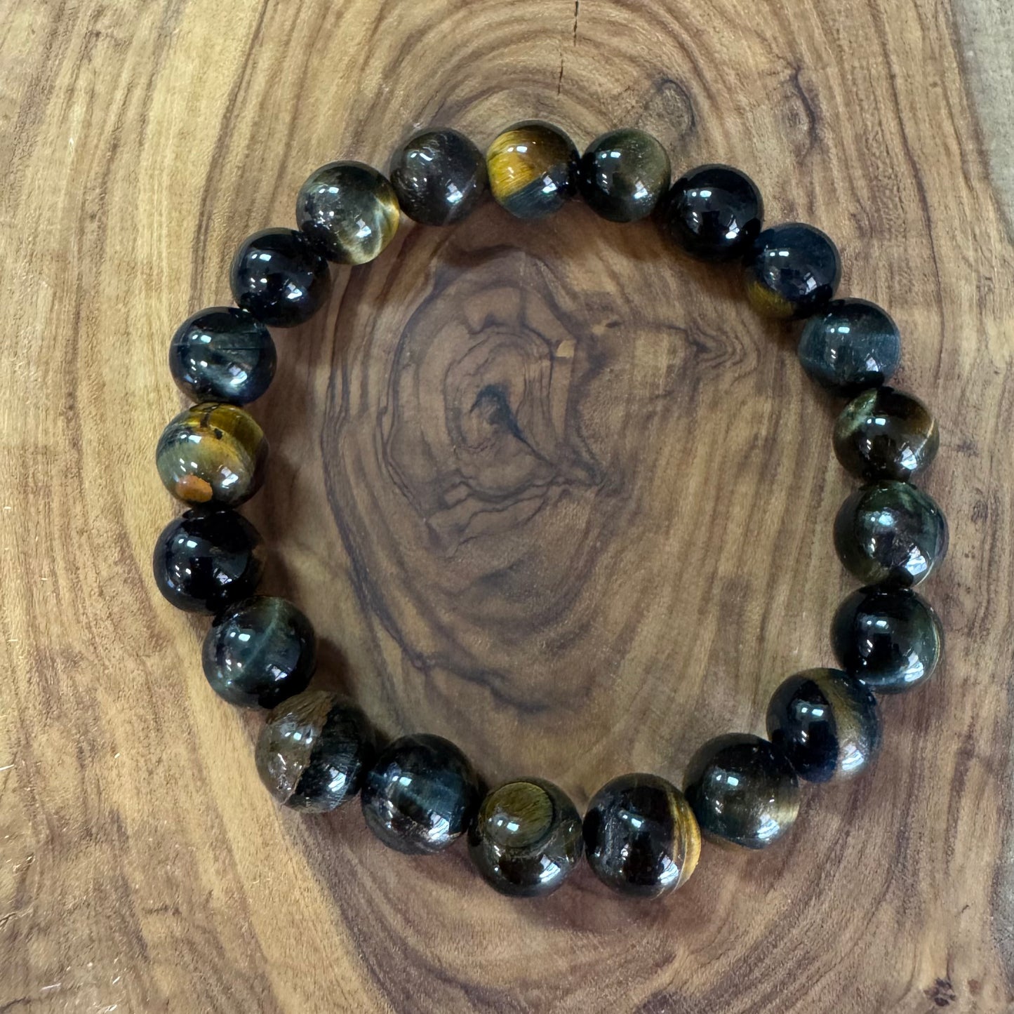 Black and brown beaded bracelet on a wooden surface