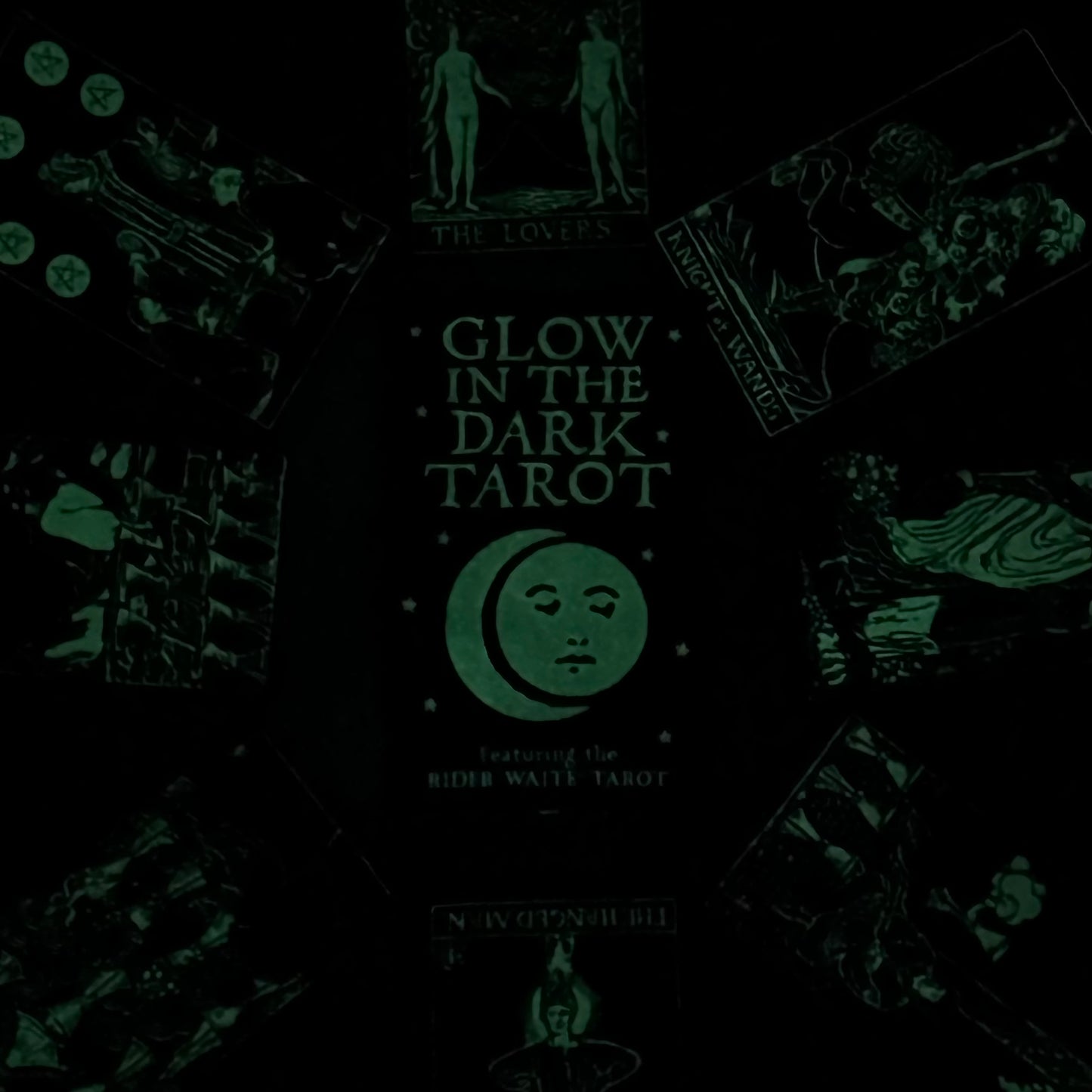Glow-in-the-dark tarot cards with packaging on a dark background