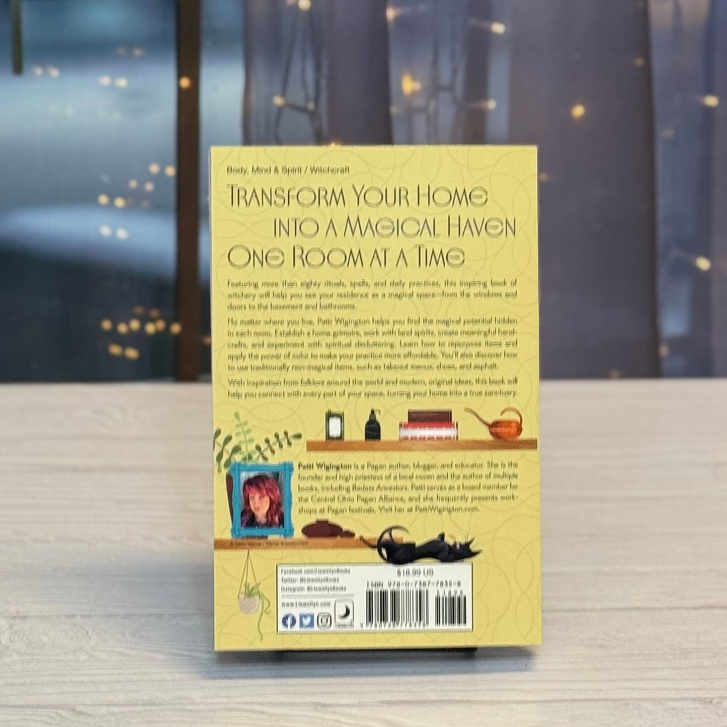Book cover with text and illustrations on a wooden surface