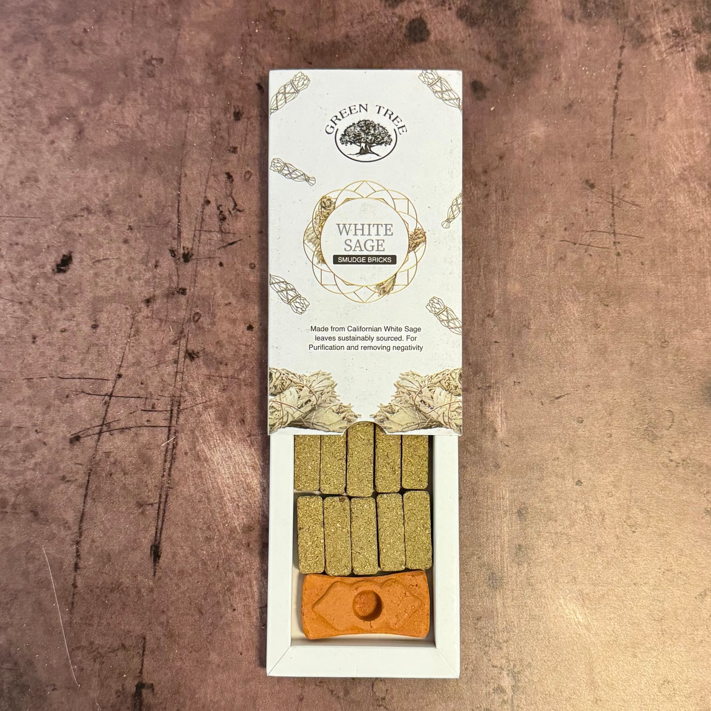 White Sage smudge stick packaging on a textured brown background