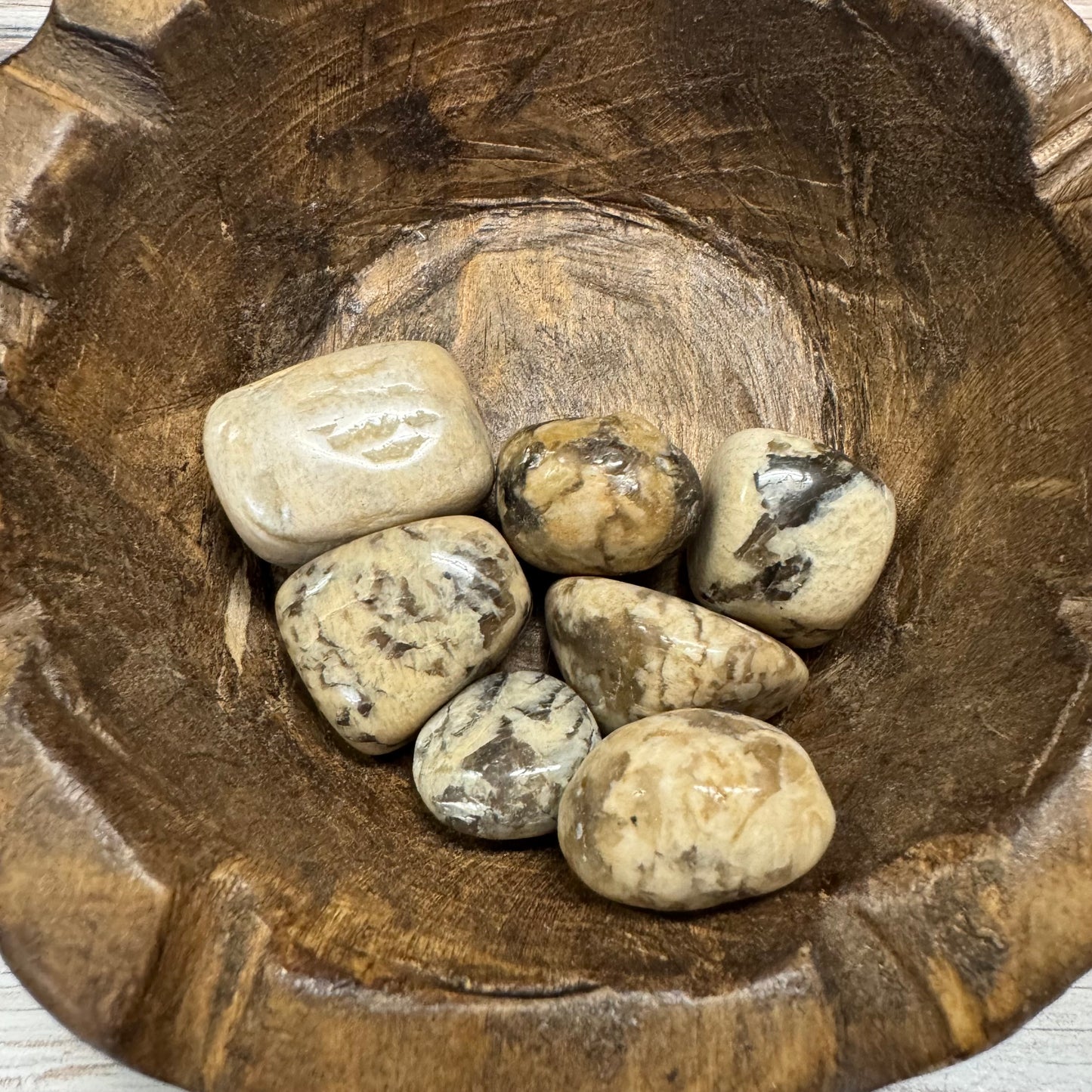 Wooden bowl with stones inside