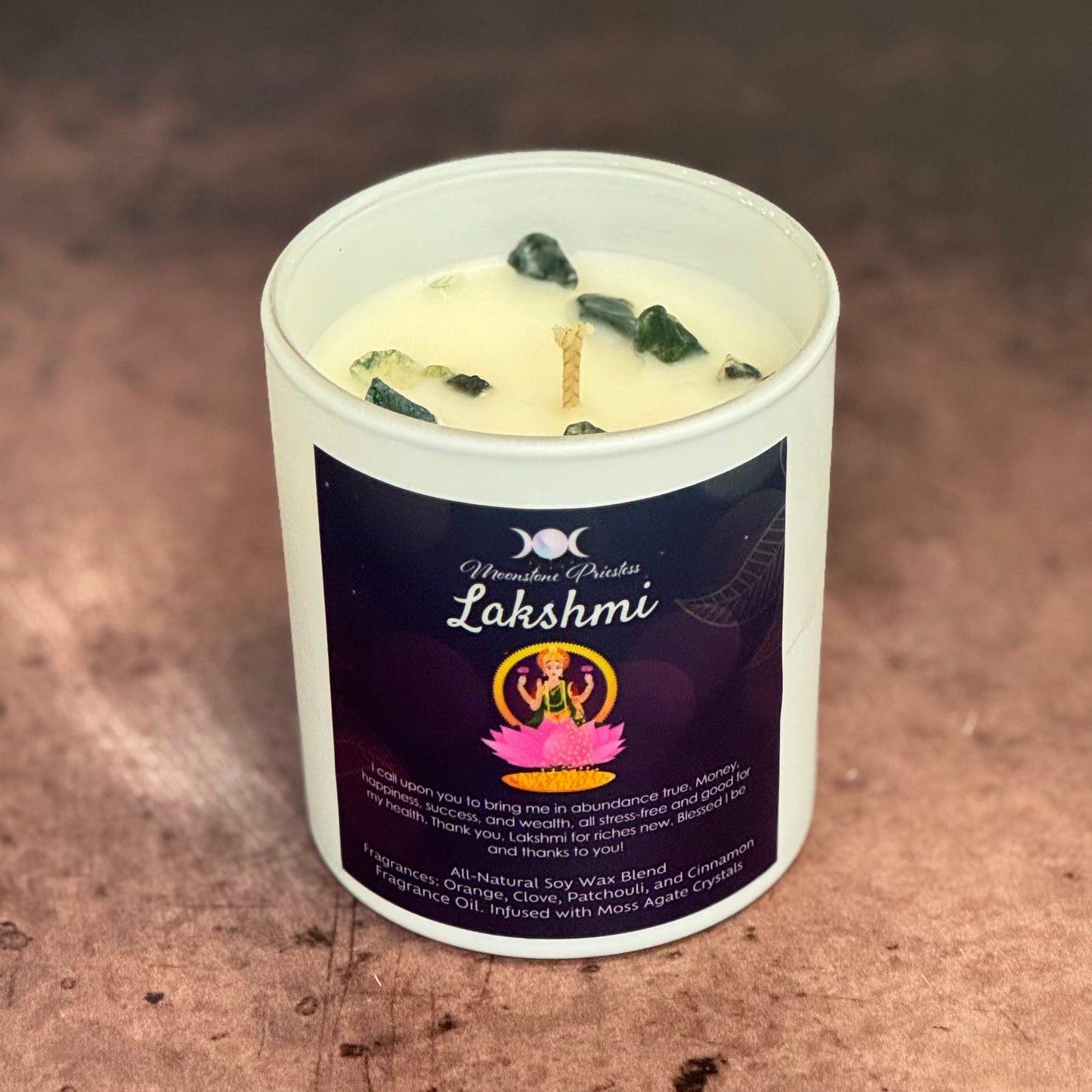 Candle in a white container with a label on a brown surface