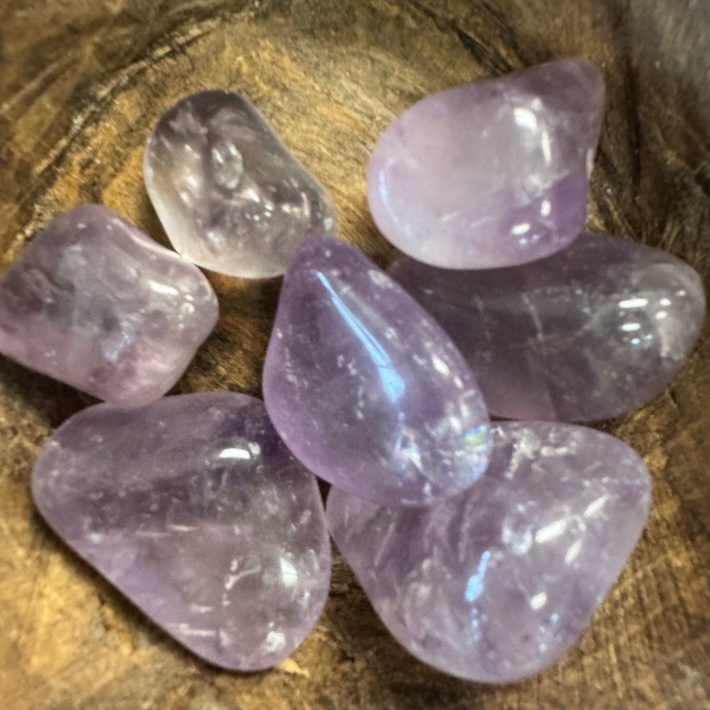 Purple crystals on a wooden surface