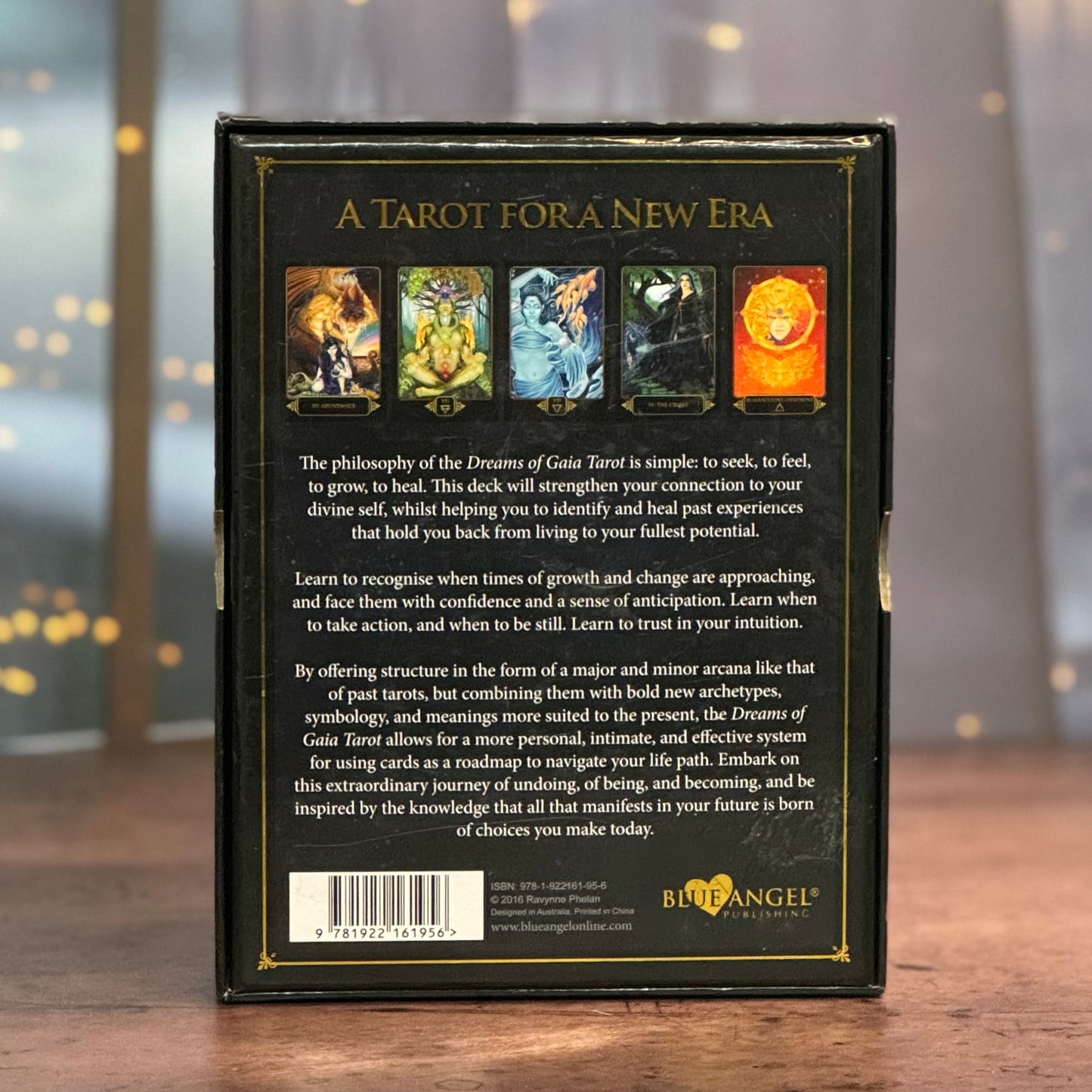 Back cover of a tarot card book titled 'A Tarot for a New Era' with tarot card illustrations on a blurred background.