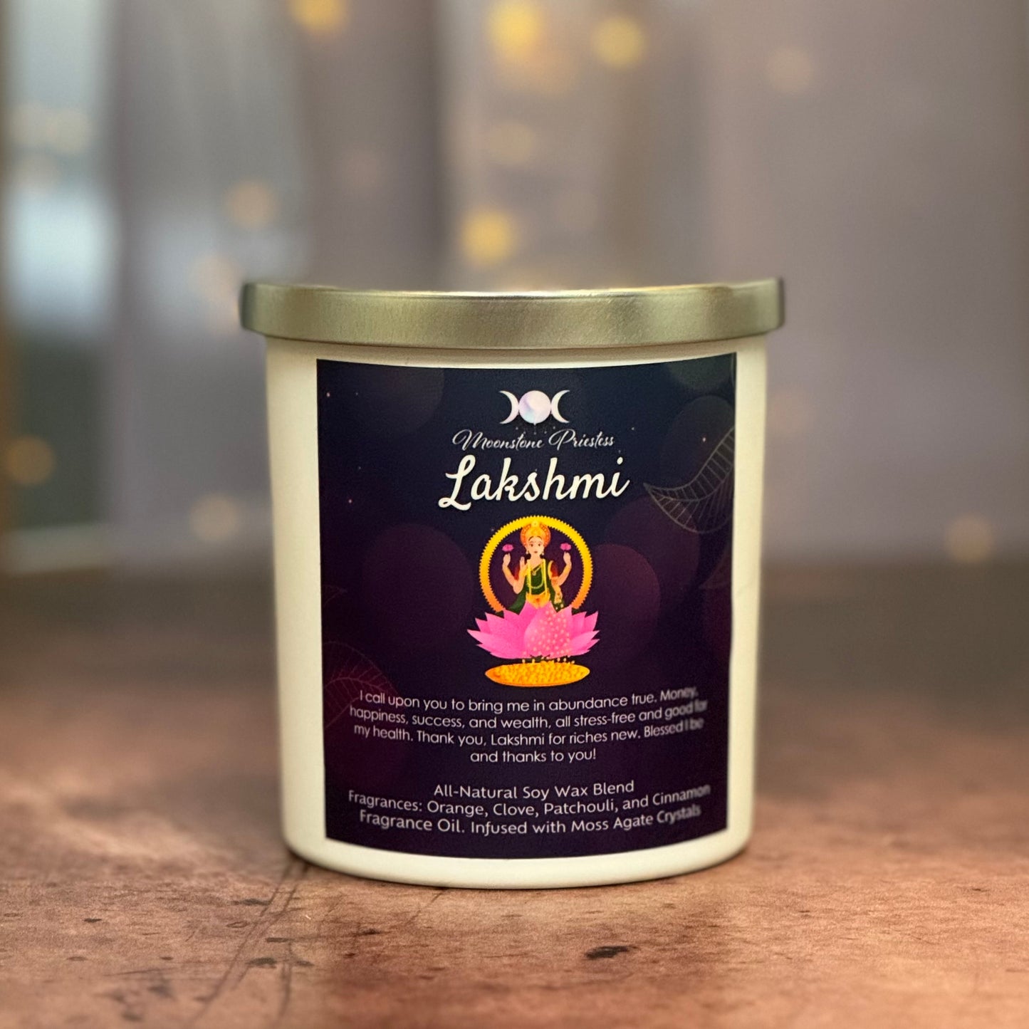 Candle with 'Lakshmi' label on a wooden surface