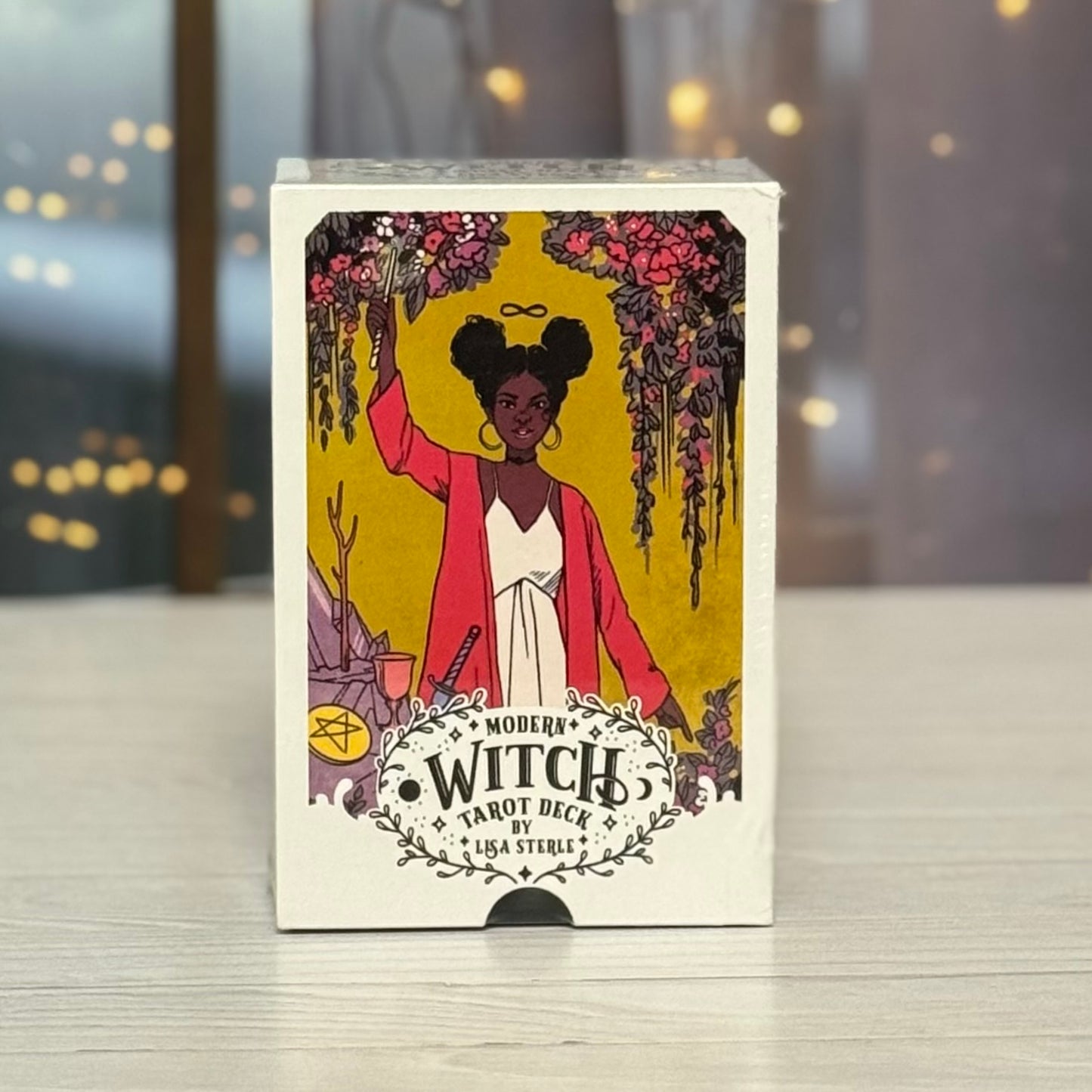 Cardboard box of 'Modern Witch Tarot Deck' with an illustration of a woman on the cover.
