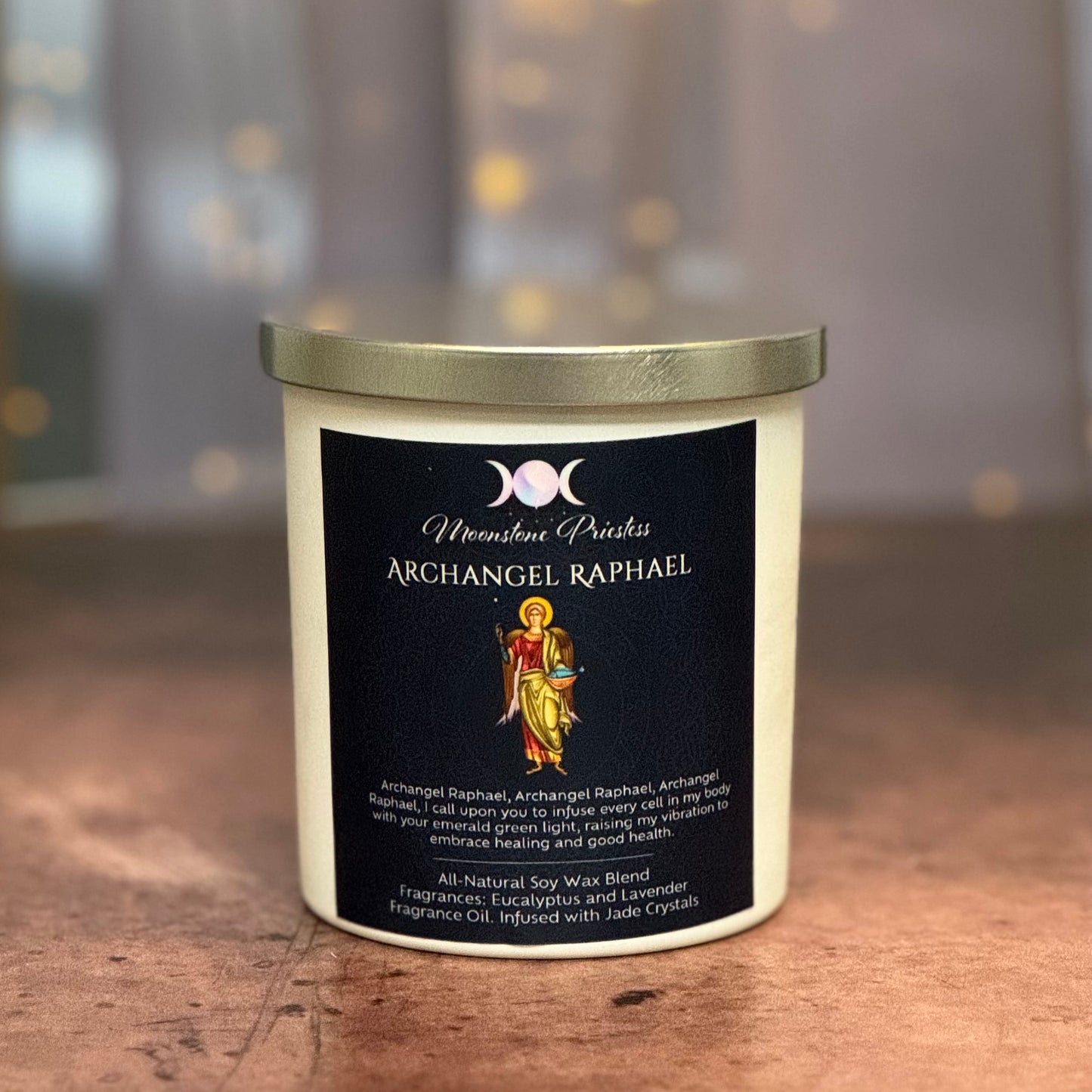 Candle with 'Archangel Raphael' label on a wooden surface