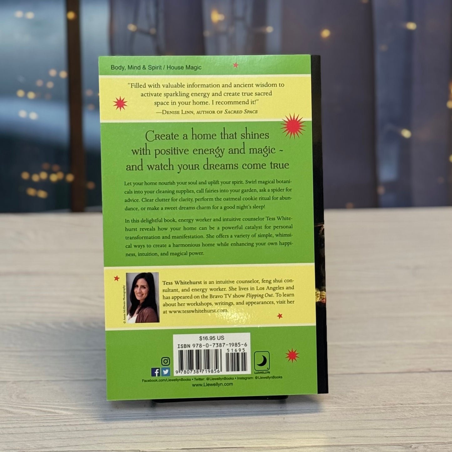 Book cover with green background and text on a wooden surface