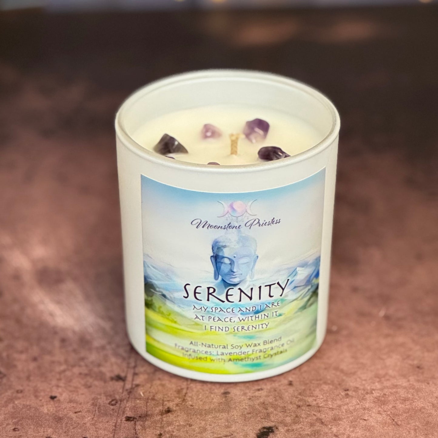 Serenity candle with a label on a wooden surface