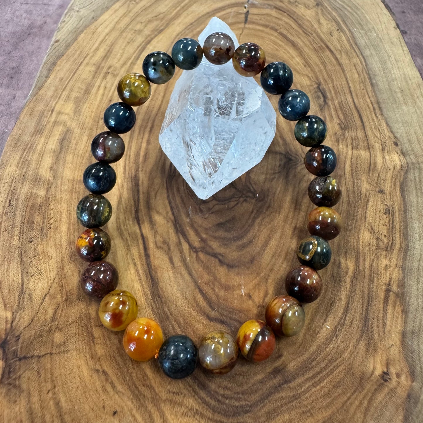 Gemstone bracelet with multicolored beads on a wooden surface