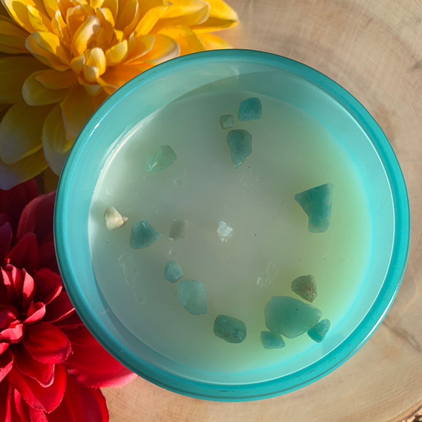 🕯️This photo displays the aqua-colored mermaid jar representing mysticism, intuition and connection to the divine feminine with amazonite, known as the stone of courage and truth that enhances communication and expressions of the heart.🕯️