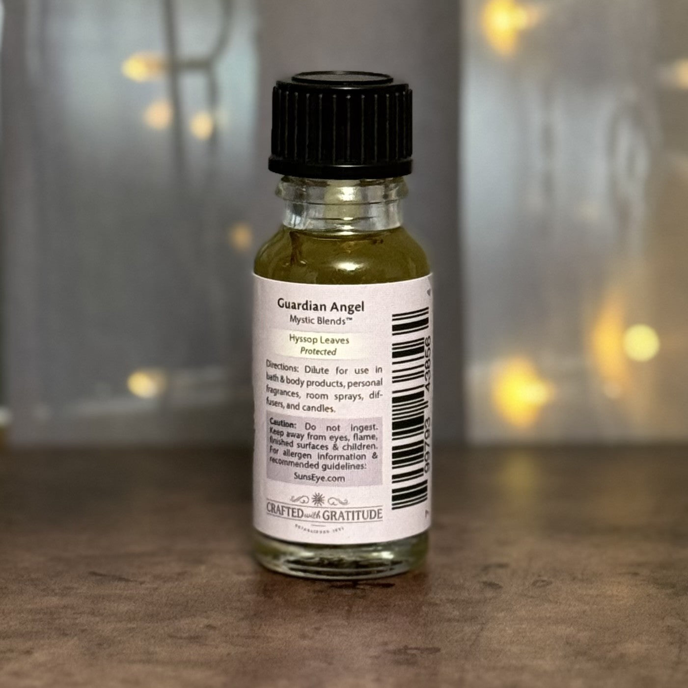 Small bottle with a label on a wooden surface with a blurred background
