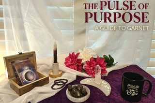 Garnet crystals and Dahlia Noir candle for grounding and passion rituals