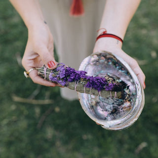 Smudge stick with lavender over abalone shell