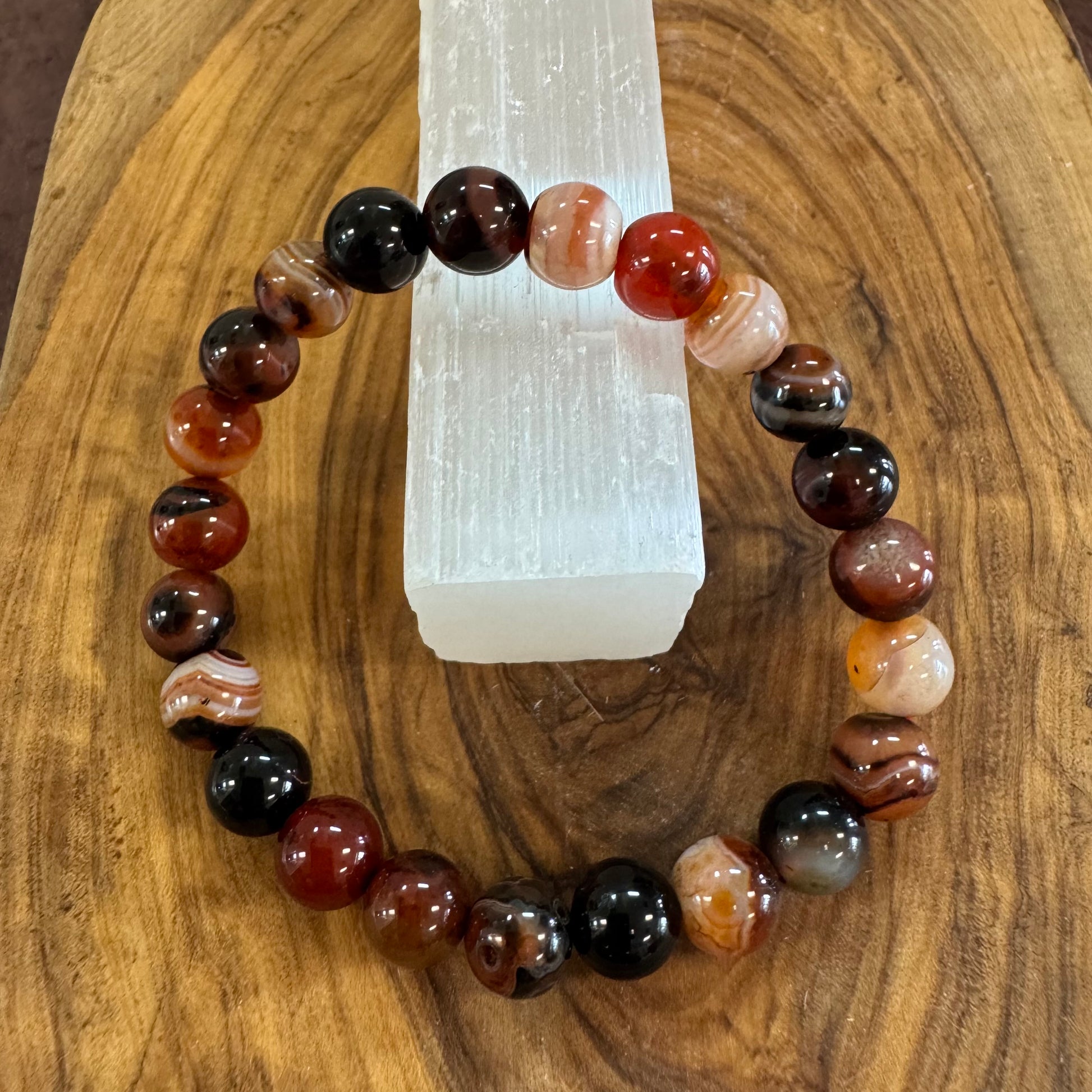 Beaded bracelet with multicolored stones on a wooden surface