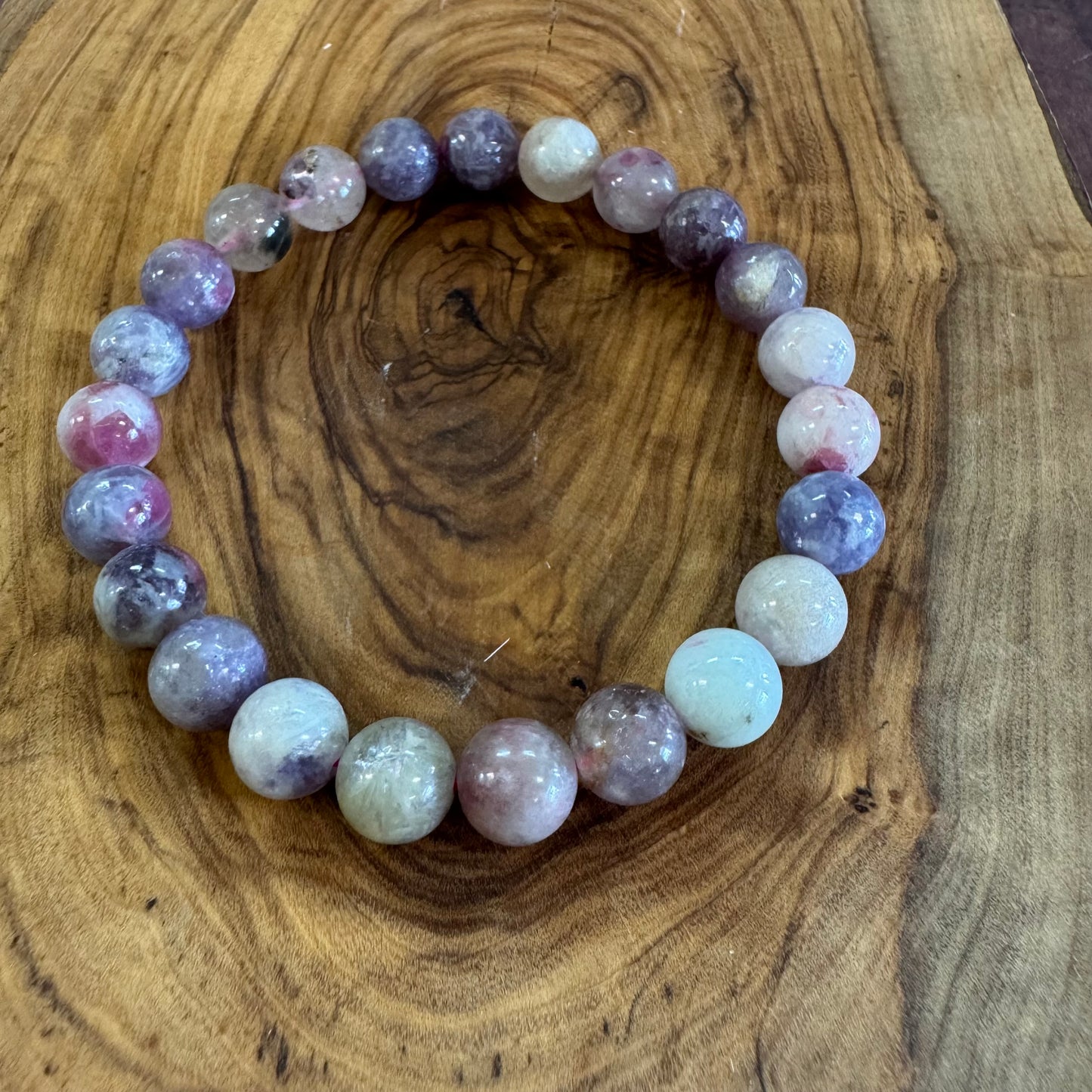 Multicolored beaded bracelet on a wooden surface