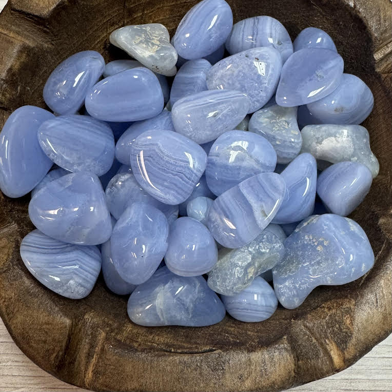 Blue stones in a wooden bowl
