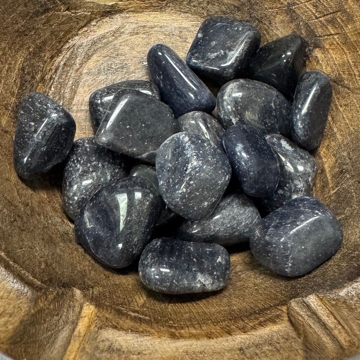 Dark gray stones on a wooden surface