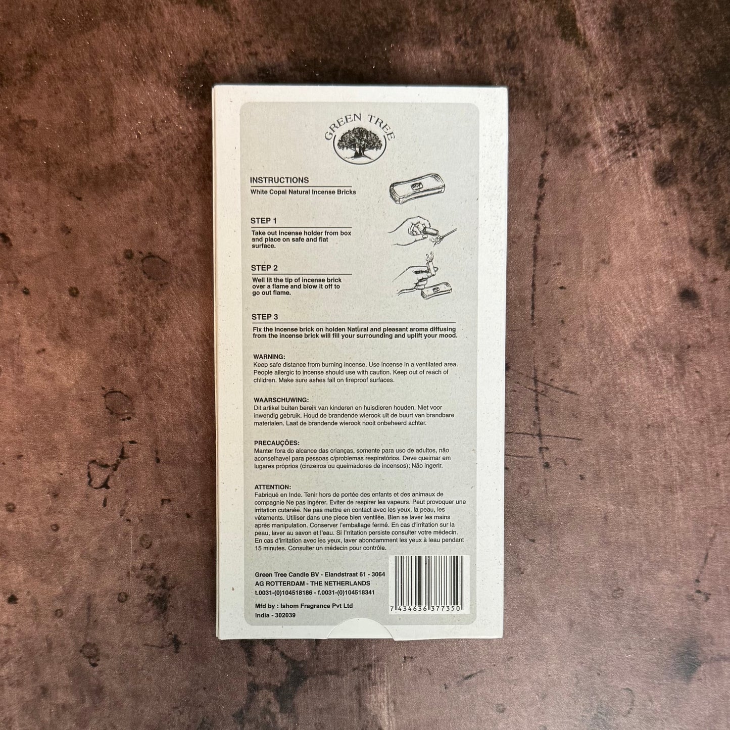 Back of a product packaging with text and a barcode on a textured brown surface
