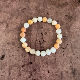 Beaded bracelet with multicolored beads on a textured brown background
