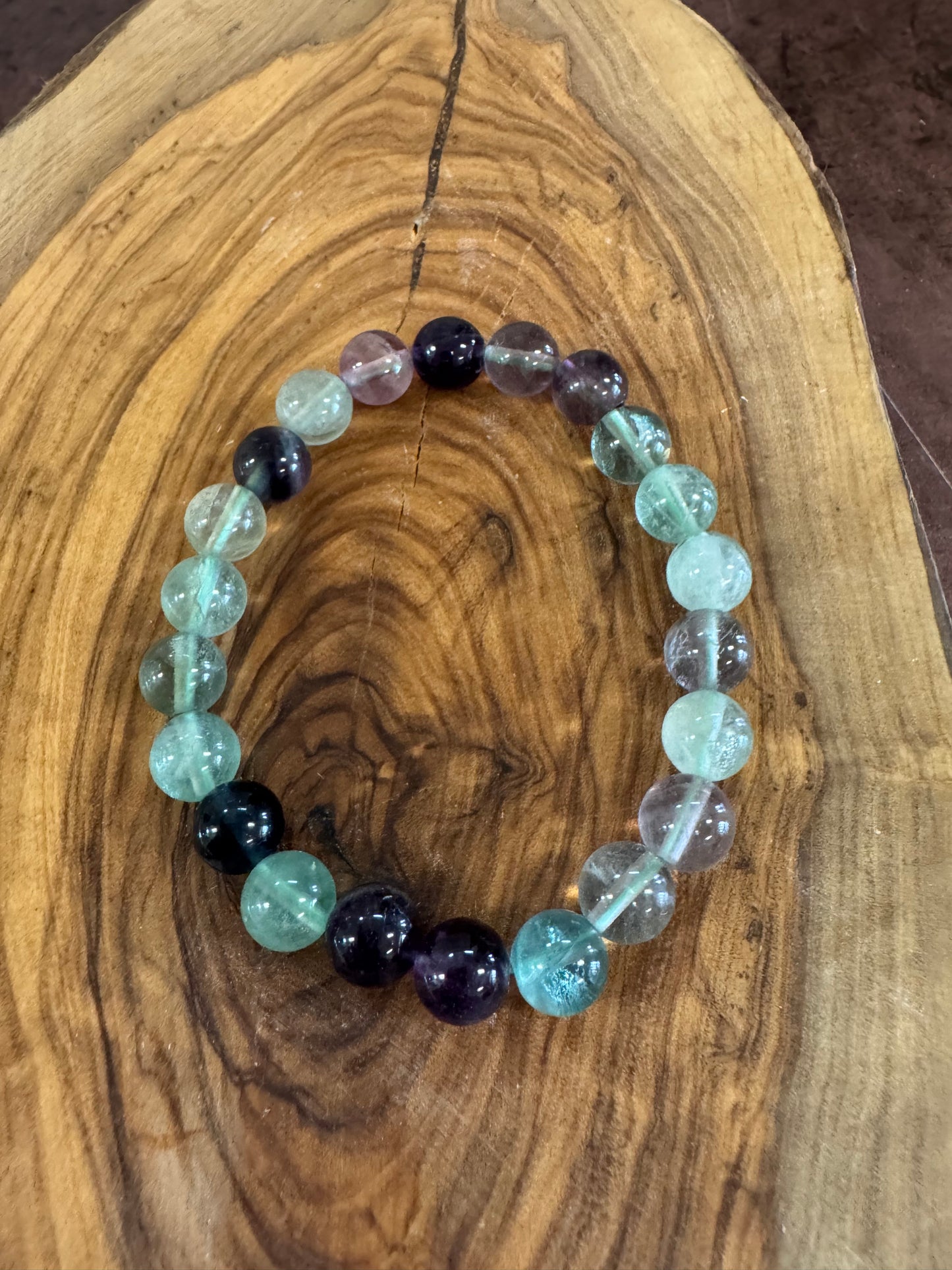 Multicolored beaded bracelet on a wooden surface