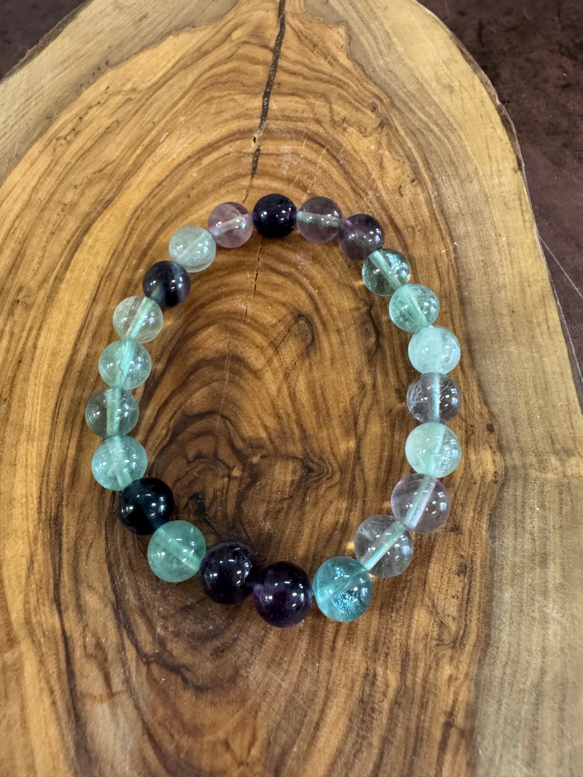 Multicolored beaded bracelet on a wooden surface