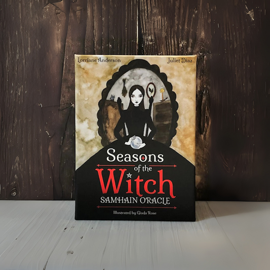 Book titled 'Seasons of the Witch Samhain Oracle' on a wooden surface with a dark background