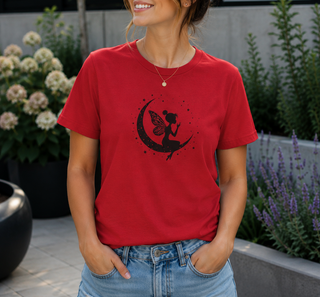 Red Fairy on Crescent Moon t-shirt with a black fairy and stars design, worn outdoors