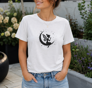 Ash Fairy on Crescent Moon t-shirt with a black fairy and stars design, worn outdoors