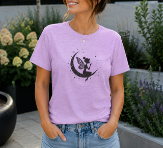Heather Prism Lilac Fairy on Crescent Moon t-shirt with a black fairy and stars design, worn outdoors