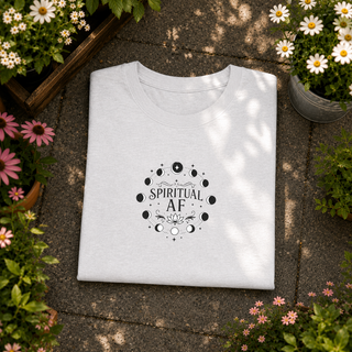 Folded Ash grey Spiritual AF moon phase tee on a stone surface with flowers