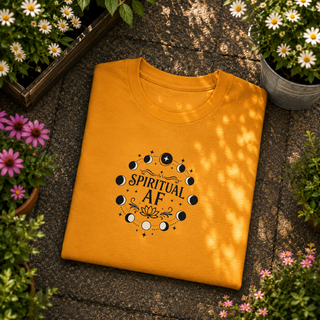 Folded Mustard yellow Spiritual AF moon phase tee on a stone surface with flowers