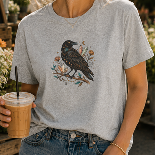 Crow Moon tee featuring a hand-drawn crow with crescent moons and florals, worn by a model