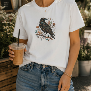 Crow Moon tee featuring a hand-drawn crow with crescent moons and florals, worn by a model