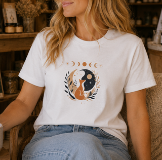 Folded White Celestial Fox tee with a fox yin-yang, moon phases and botanicals